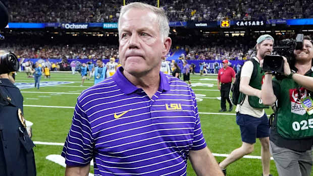 LSU coach Brian Kelly walks off field after opening-season loss.